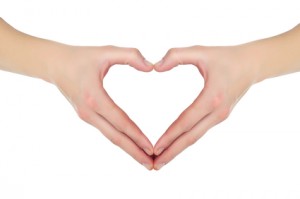 female hands in the form of heart isolated on white background